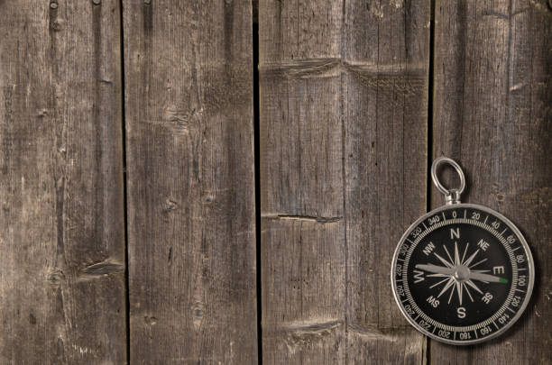 Cowboy hat on barn wood texture background with beautiful bokeh and colored light. American wild west concept. Can be used as a template with lots of empty space for copy.