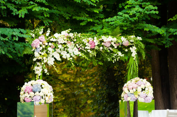 istock Wedding arch for ceremony with beautiful bouquet in the park 1009116736
