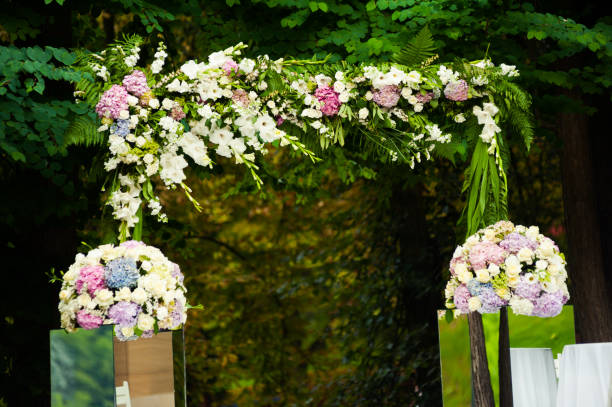 istock Wedding arch for ceremony with beautiful bouquet in the park 1009116748