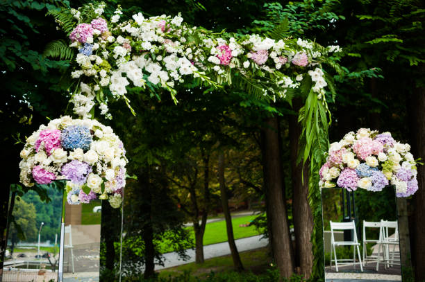 istock Wedding arch for ceremony with beautiful bouquet in the park 1009118982