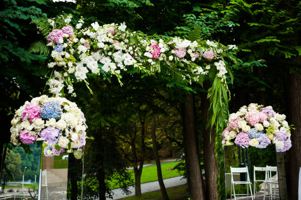 istock Wedding arch for ceremony with beautiful bouquet in the park 1009119018