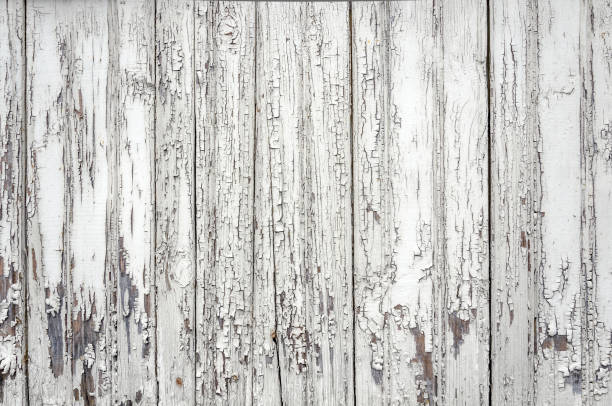istock Cracked aged surface white painted wooden planks texture background backdrop 1009119042