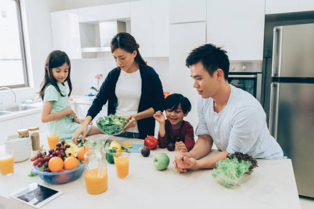 istock Happy family cooking together 1009130096