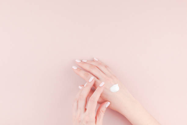istock Woman moisturizing her hand with cosmetic cream 1009130296