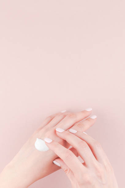 istock Woman moisturizing her hand with cosmetic cream 1009130316