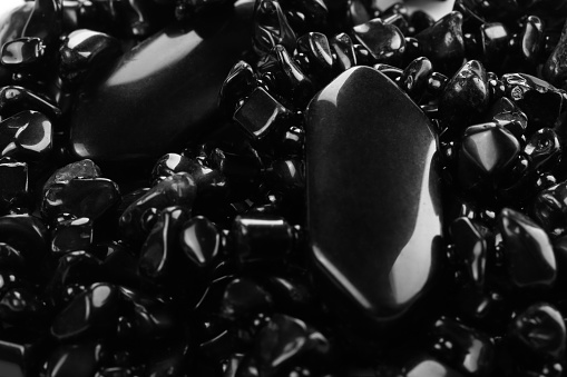 Decorative women's beads of black stones close-up. Details. Abstract background