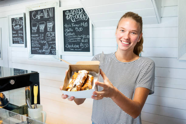 istock A young woman working behind a pastry counter in a cafe 1009140024