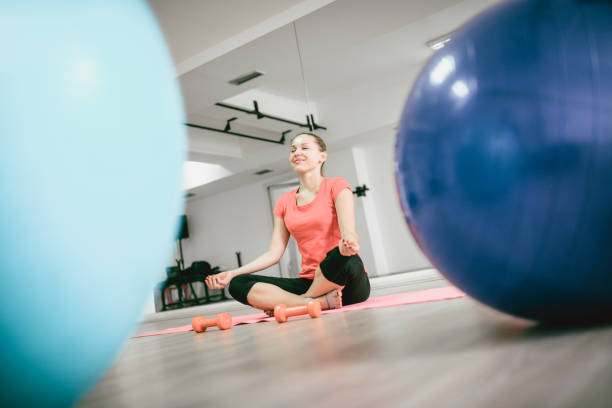 istock Female Athlete Meditating After Cross Training In Gym 1009144986