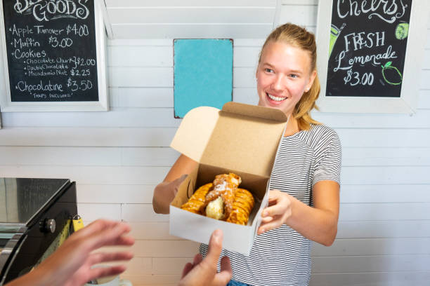 istock A young woman working behind a pastry counter in a cafe. 1009147438