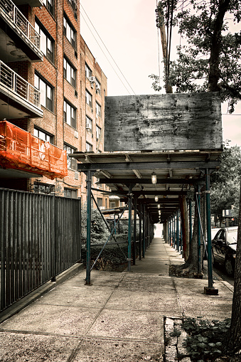 As a building's exterior is being repaired, New York City law requires that a Sidewalk Overhead Protection Scaffold be constructed for the protection of pedestrians passing by. These structures are also called a 