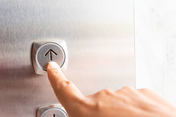 istock Close up waman hand press a up button of elevator inside the building for upper high level floor. 1009208402