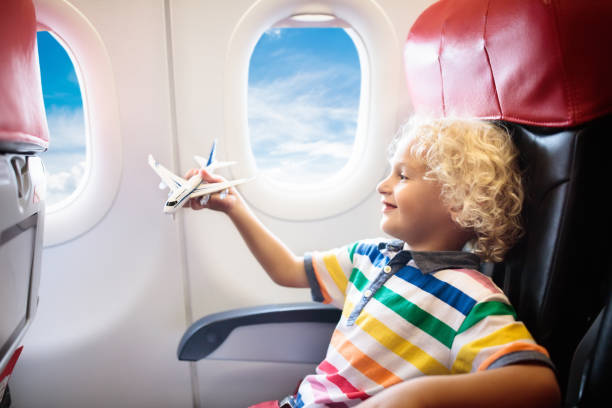 istock Child flying in airplane. Flight with kids. 1009213838
