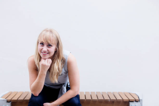 istock beautiful caucasian woman sit and relax with grey background 1009216076