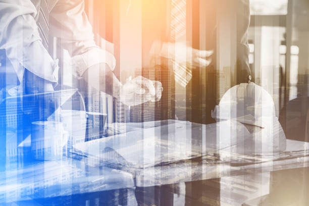 istock double exposure  BUSINESS MEETING AND CONSULTING CONCEPT WITH PEOPLE ENGINEER AND ARCHITECT 1009216274