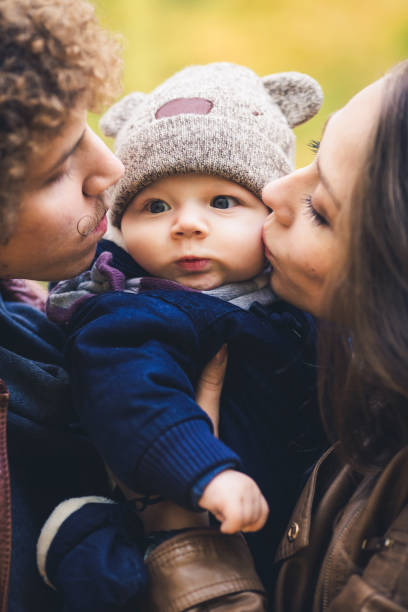 istock Young family hugging in autumn in park. 1009216590