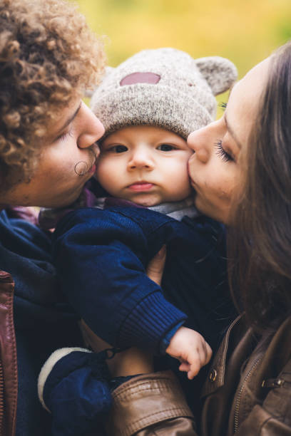 istock Young family hugging in autumn in park. 1009216604