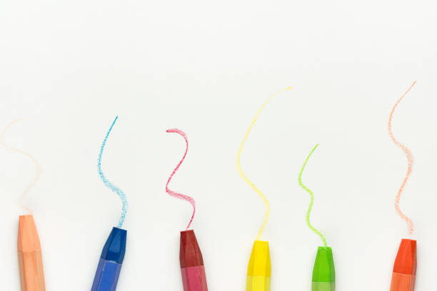 istock Row of Colorful Multicolored Pastel Wax Crayons on White Paper with Hand Drawn Scribbles. Back to School Kids Arts Creativity Drawing Hobby Concept. Poster Banner Template with Copy Space 1009219374