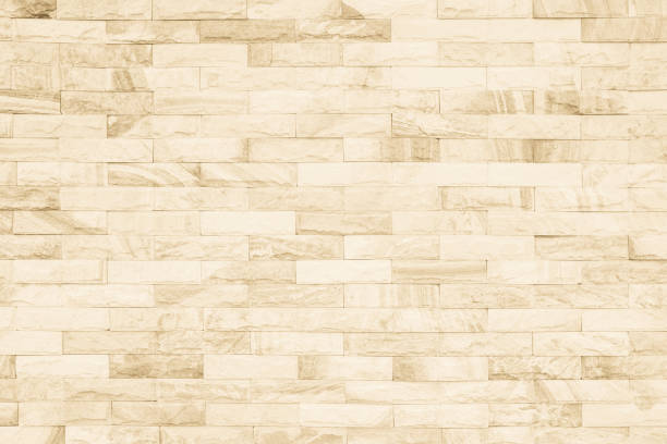istock Cream and white brick wall texture background. Brickwork or stonework flooring interior rock old pattern clean concrete grid uneven bricks design stack. 1009257056