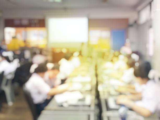 istock Blurred image of group of students are learning and lecture and using computer together in classroom for study and workshop in computers room at school. education technology or training concept. 1009266668