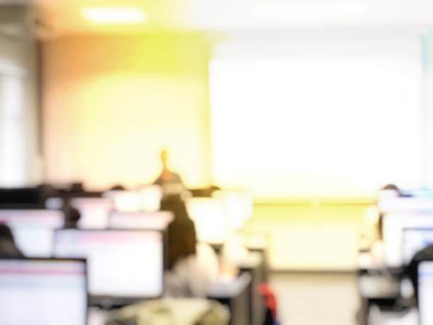 istock Blurred image of group of students are learning and lecture and using computer together in classroom for study and workshop in computers room at school. education technology or training concept. 1009266674