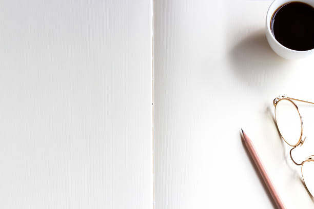 istock Notebook, pencil, and cup of coffee on the table. Space for your text or message. 1009282012