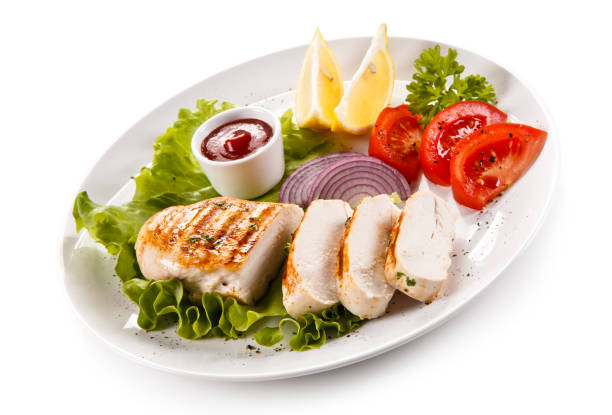 istock Grilled chicken breast and vegetables on white background 1009286546