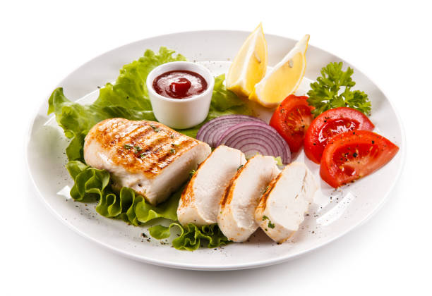 istock Grilled chicken breast and vegetables on white background 1009286616