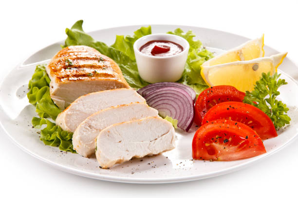 istock Grilled chicken breast and vegetables on white background 1009286726