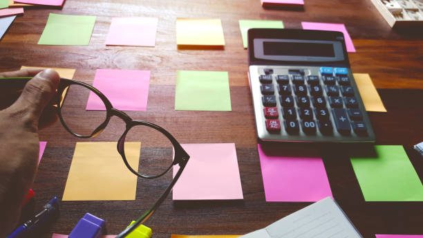 Glasses and Notes paper supplies on desktop wood table. Brainstorming Brainstorm concept