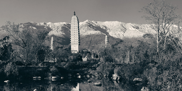 Ancient pagoda in Dali old town with snow capped Mt Cangshan, Yunnan, China.