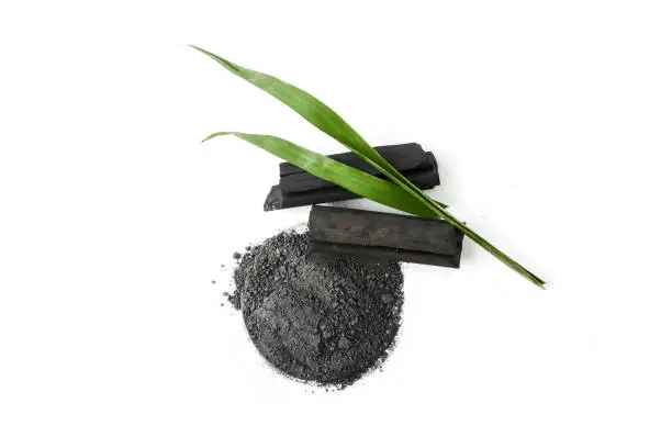 Photo of Activated charcoal powder on white background