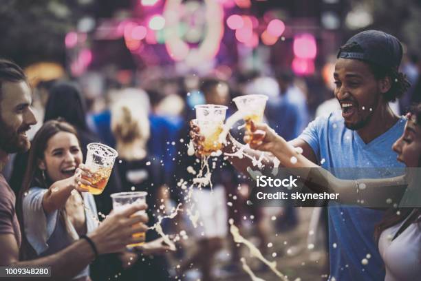 Group Of Cheerful Friends Having Fun With Beer On A Music Concert Stock Photo - Download Image Now