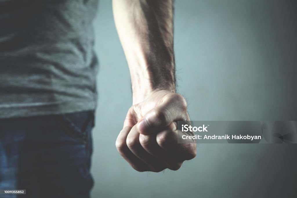 Caucasian angry and aggressive man threatening with fist. Fist Stock Photo