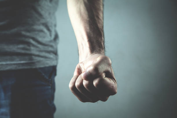 Caucasian angry and aggressive man threatening with fist. stock photo