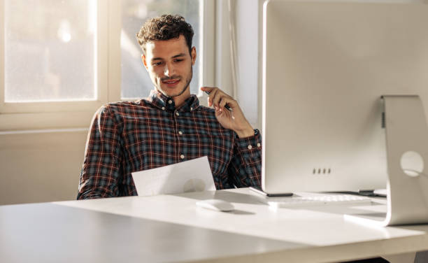 istock Businessman looking at business papers in office 1009362352