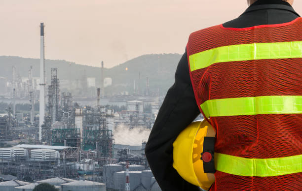 istock Hand or arm of engineer hold yellow plastic helmet 1009372138