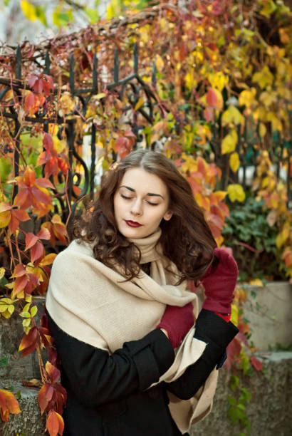 istock woman in a  coat walks in autumn park 1009383874
