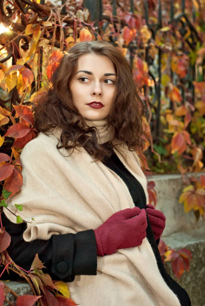 istock woman in a  coat walks in autumn park 1009383894