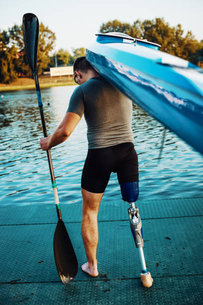 istock Amputee athlete holding his kayak 1009394150