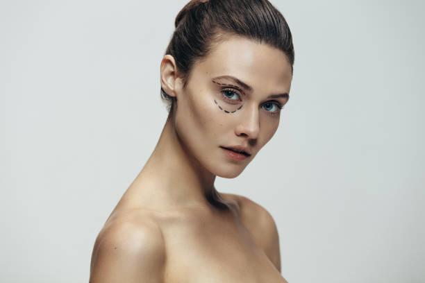 istock Woman face with dotted lines before plastic surgery 1009409022