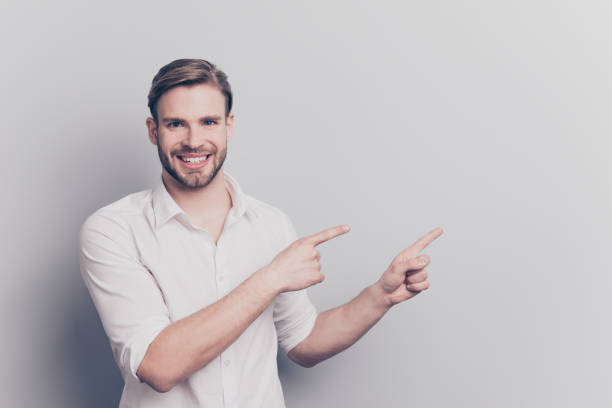 istock Look attention ! Leave your feedback here! People service tips concept. Portrait of confident excited handsome experienced manager pointing on empty blank place text isolated gray background copyspace 1009409654