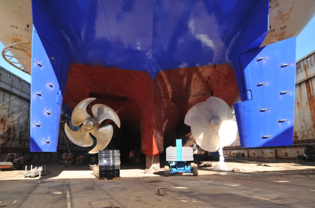 Propeller under reconstruction. Under the ship. Big ship under repairing on dry dock in shipyard