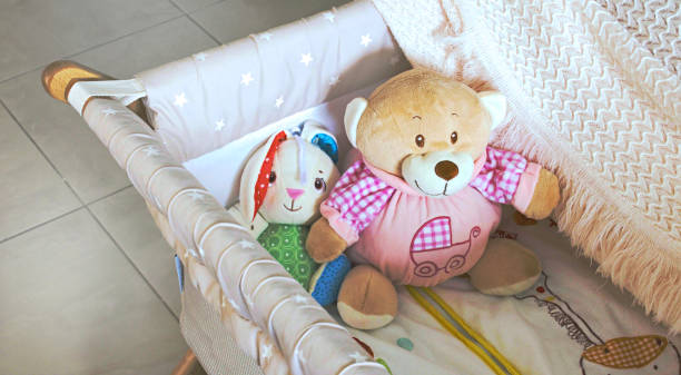istock Baby cot or crib with cute soft cuddly toys 1009424916