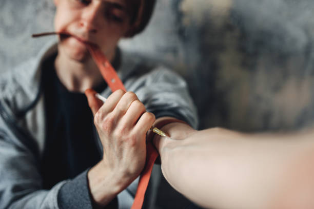istock Male junkie with syringe doing an injection dose 1009427808