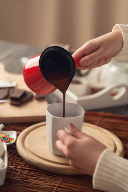 Pouring Hot Chocolate In A White Mug