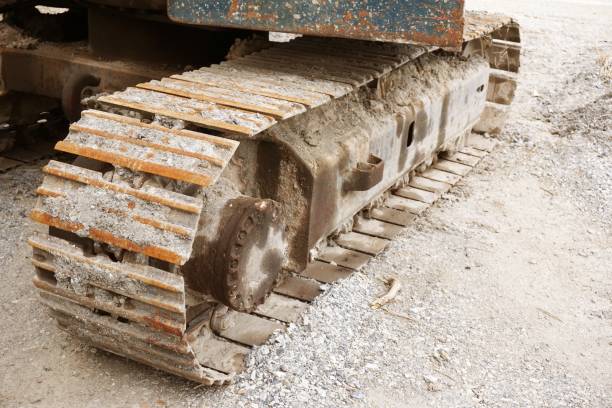 istock Close up dry mud on stuck backhoe wheels 1009439084