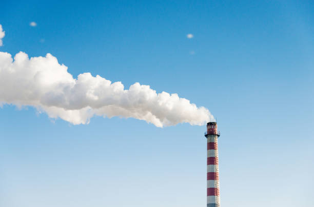 The chimney with smoke into the sky.