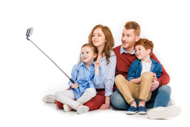 istock happy redhead family taking selfie with smartphone isolated on white 1009457114