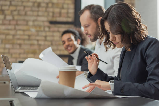 istock team of architects working on building plans at modern office 1009465128