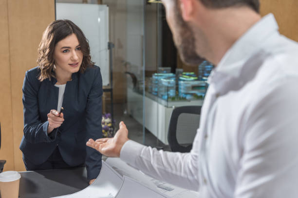 istock architects discussing building plans together at office 1009465246